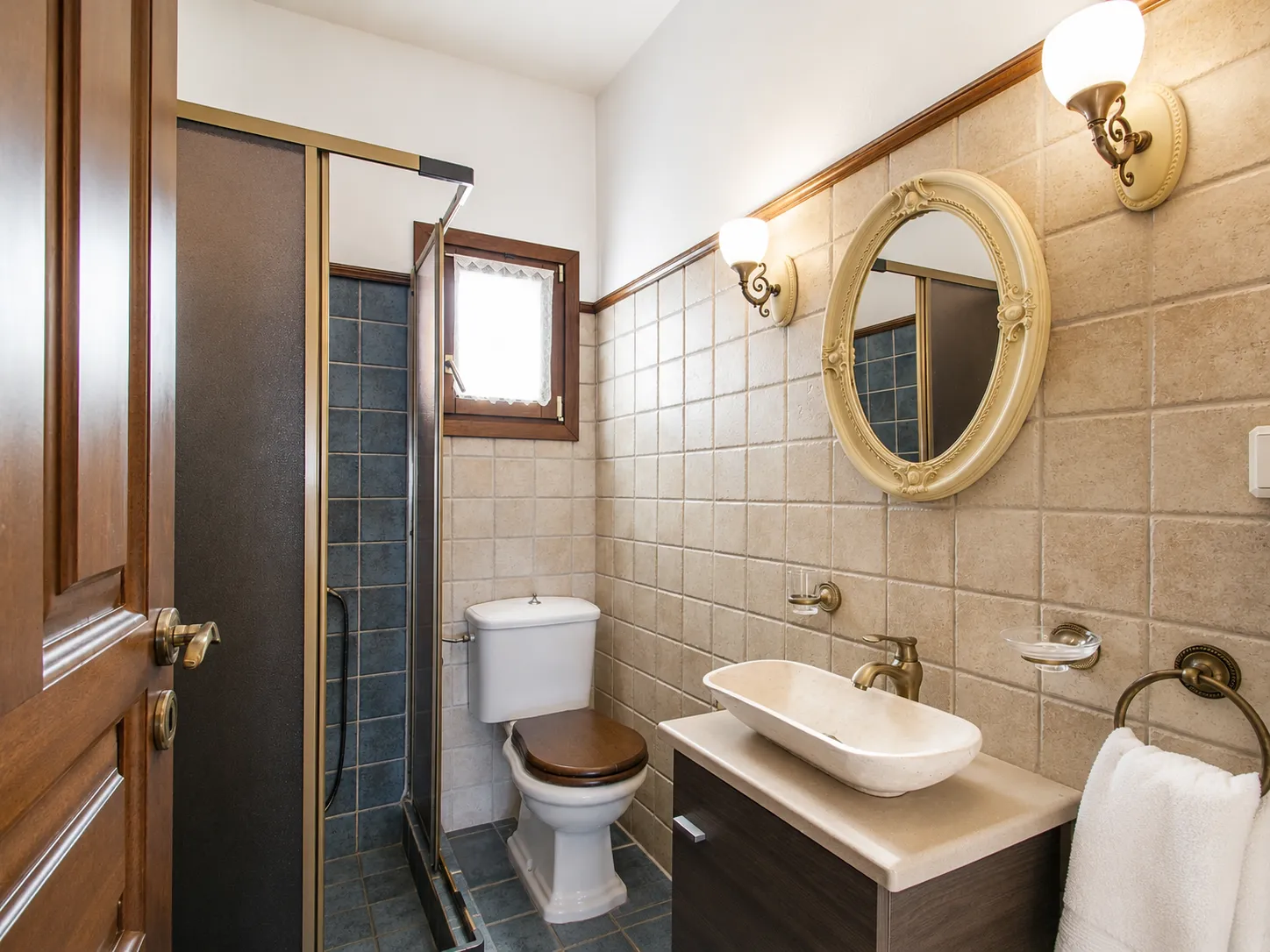 Second bathroom with walk-in shower, stone vessel sink and oval mirror, Villa Viktoria
