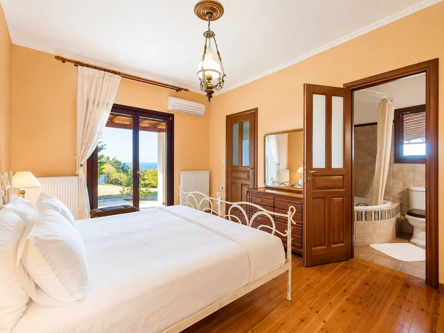 Master bedroom with en-suite bathroom and balcony doors opening to sea views, Villa Viktoria