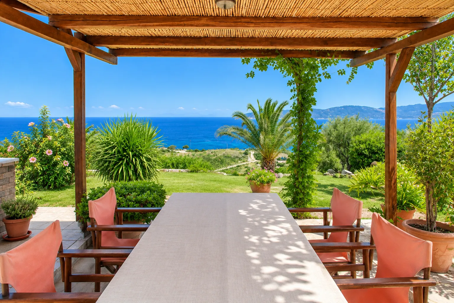 Shaded pergola dining table with panoramic Aegean Sea views at Villa Viktoria, Skiathos