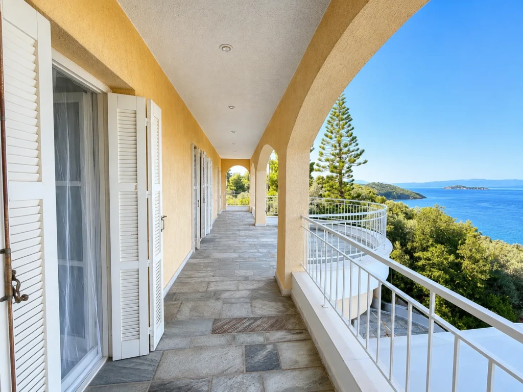 Arched upper-floor loggia connecting the bedrooms with sea views at AERON, Skiathos